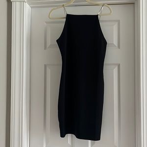 Short, Backless cocktail dress with rhinestone straps.